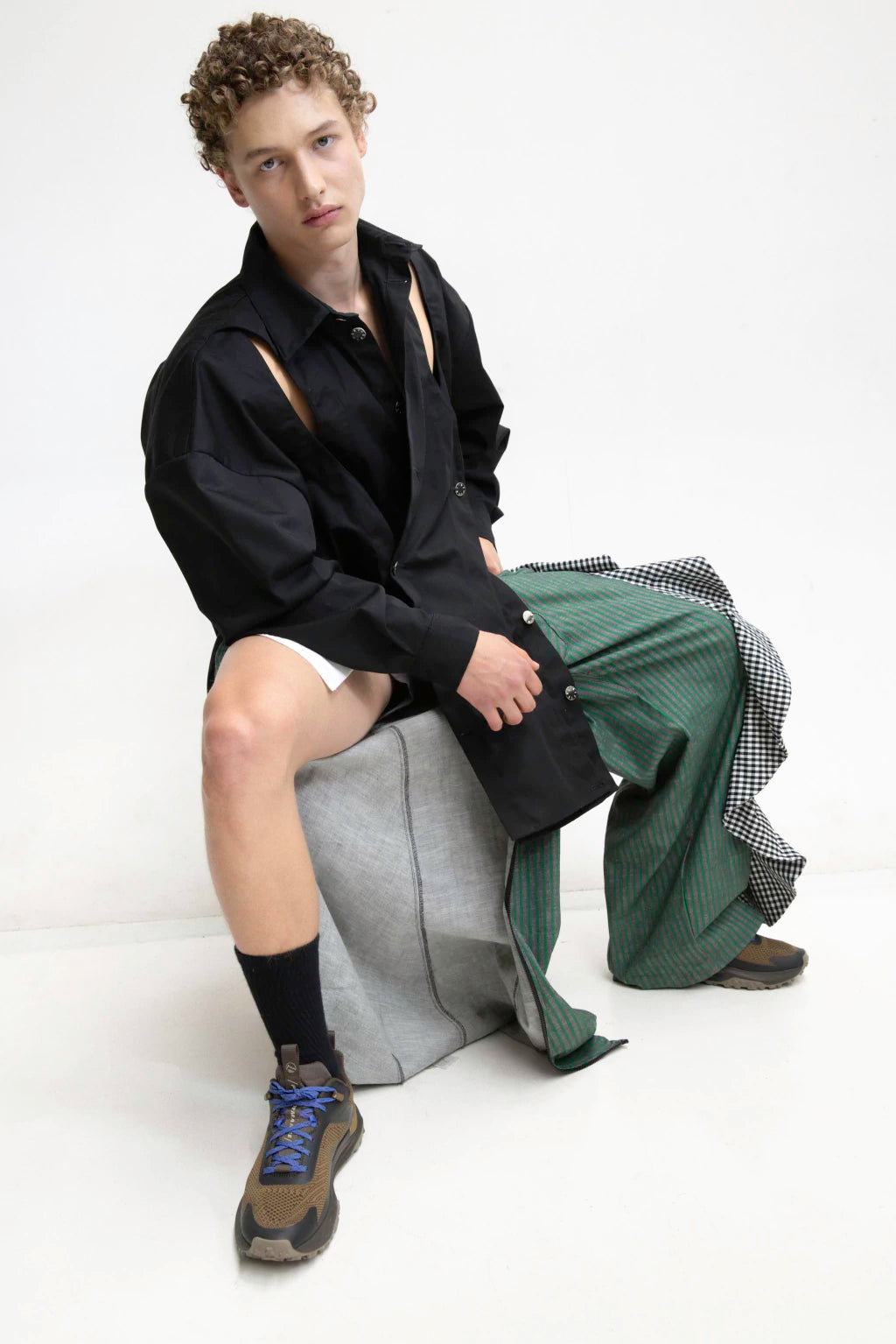 MANCANDY Crossed Garment Jacket featuring curved overlapping panels, exposed nickel buttons, shirt collar and water-repellent cotton-nylon construction.