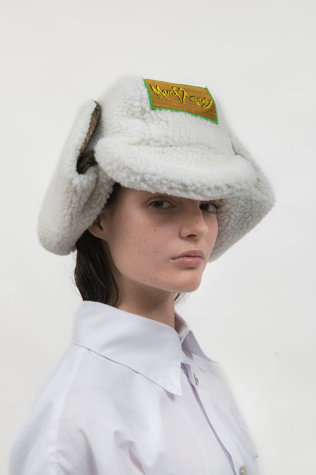 Off Duty Hat in white faux shearling with Tree Camo fleece details, shown on female model