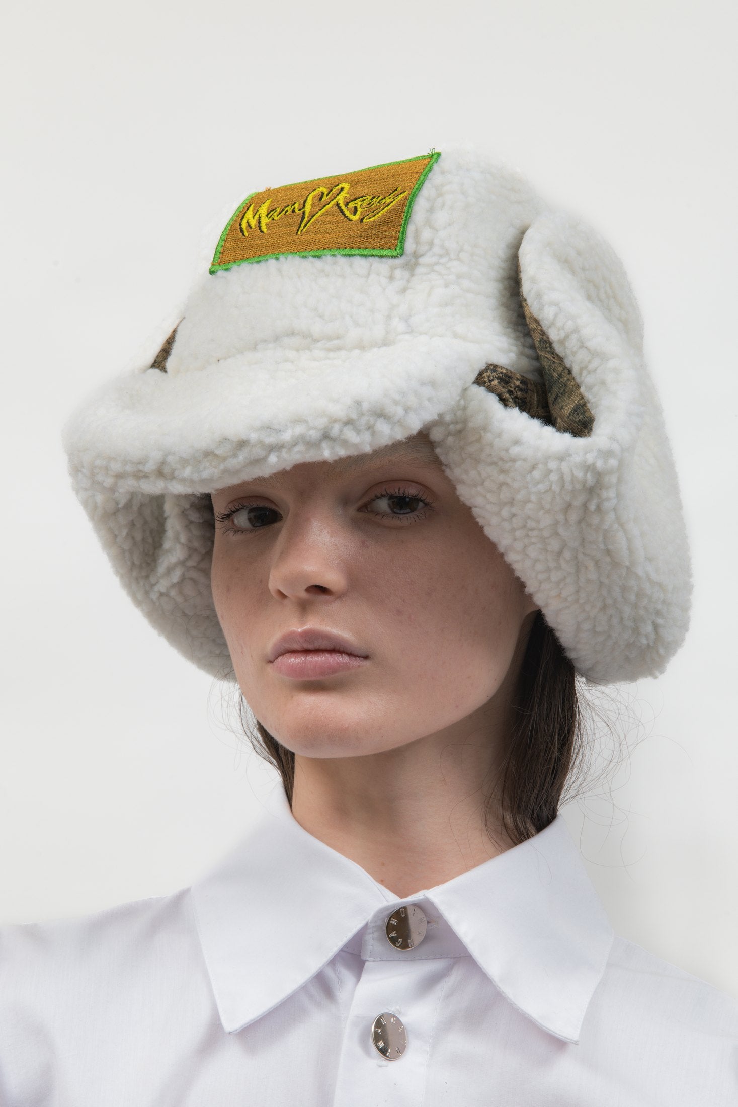 Front view of the Off Duty Hat in white faux shearling with Tree Camo fleece details
