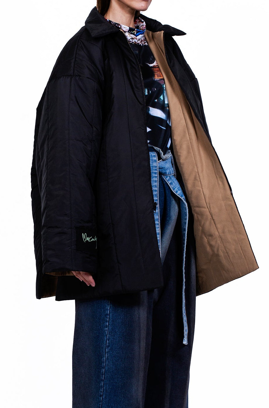MANCANDY Utility Quilted Coat in blue nylon featuring oversized quilted construction, high side slits, contrast denim chest pocket, embroidered sleeve patch and front zip closure.