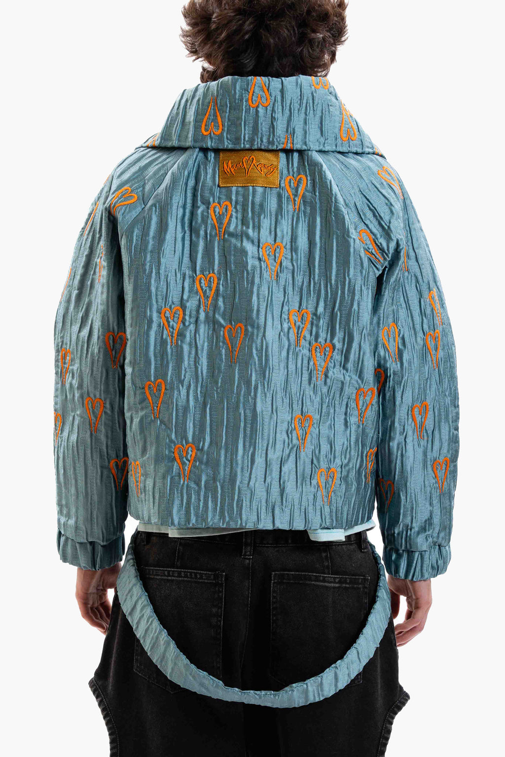 Hearts Bomber Jacket in textured blue steel fabric with all-over heart embroidery and oversized silhouette.