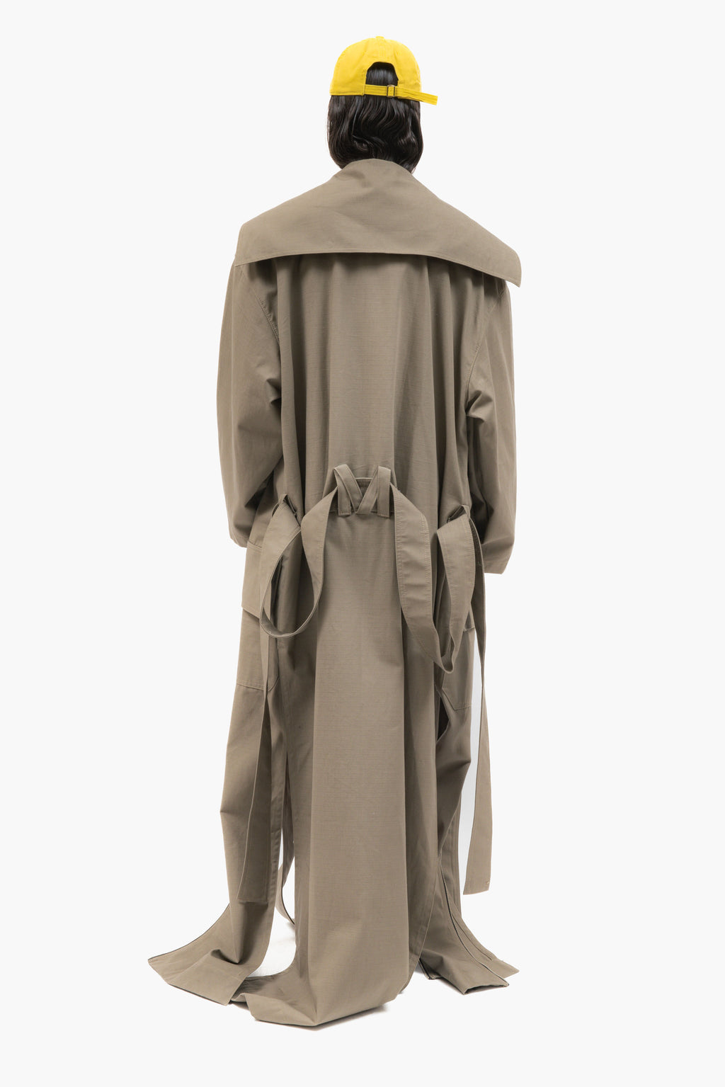 MANCANDY Dust Trench in khaki ripstop featuring an extra-long silhouette, oversized collar, utility pockets and trailing straps.