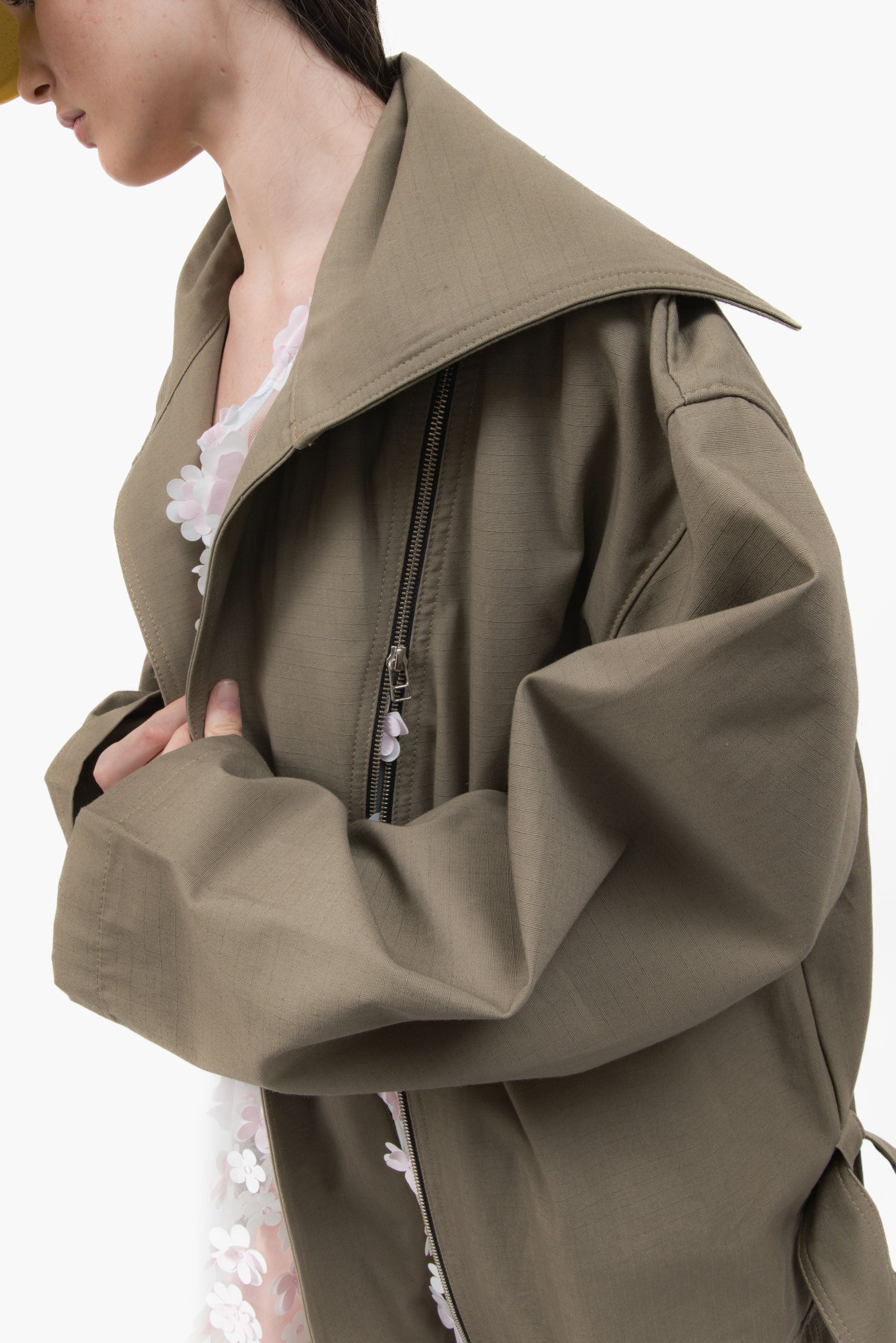 MANCANDY Dust Trench in khaki ripstop featuring an extra-long silhouette, oversized collar, utility pockets and trailing straps.