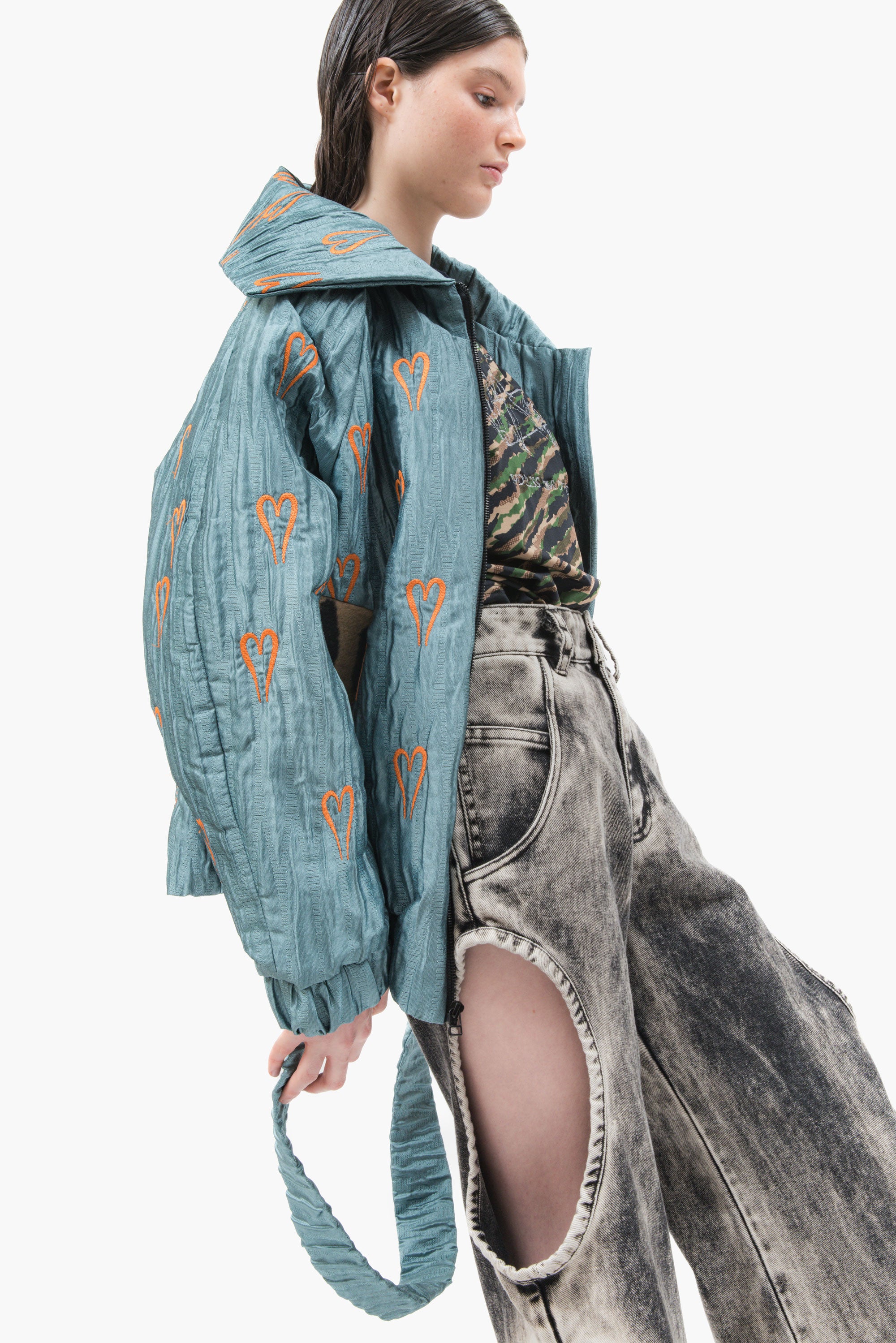 Hearts Bomber Jacket in textured blue steel fabric with all-over heart embroidery and oversized silhouette.
