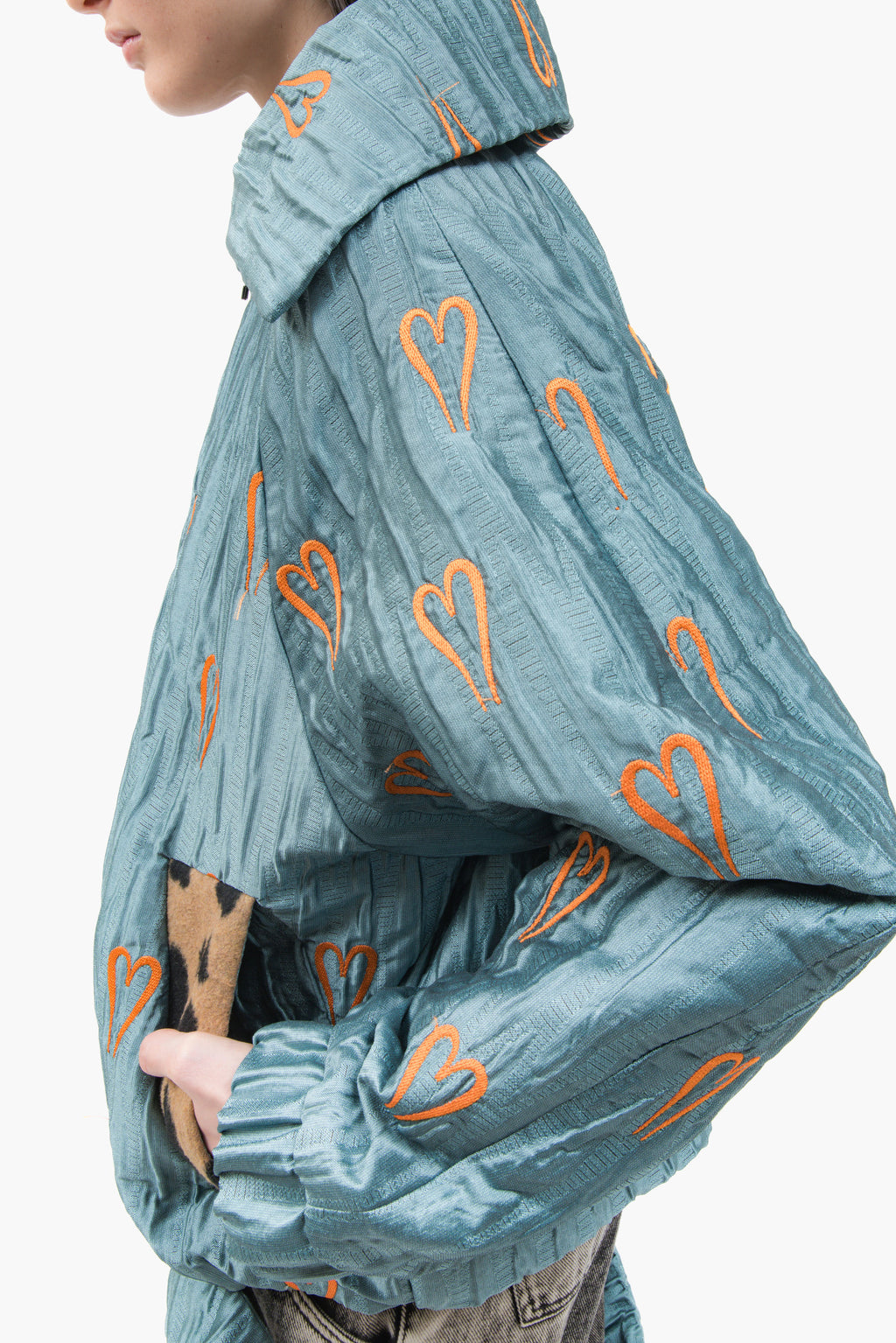 Hearts Bomber Jacket in textured blue steel fabric with all-over heart embroidery and oversized silhouette.