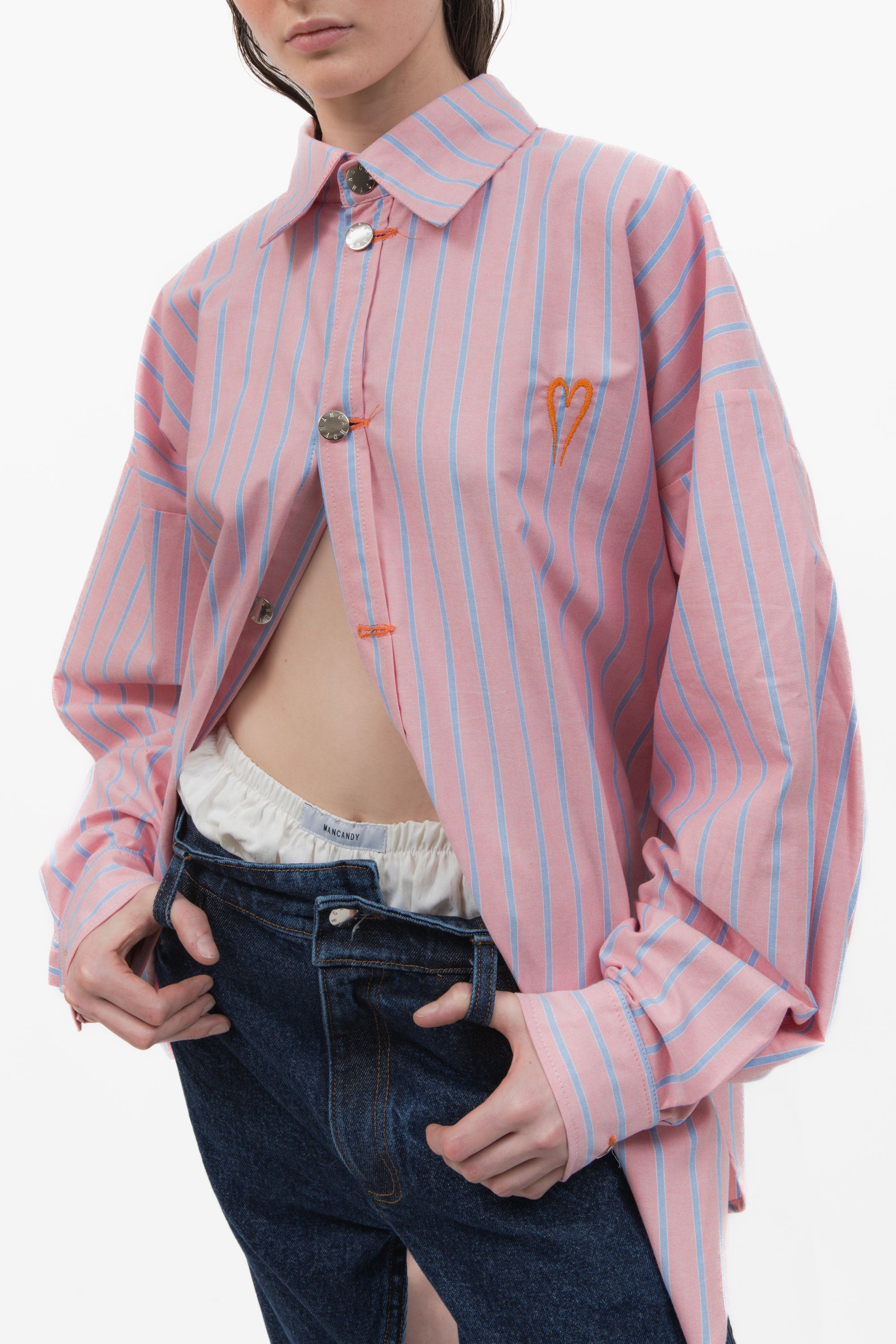 MANCANDY Monday Shirt in pink striped cotton featuring an oversized fit and orange Bladed Heart embroidery on the chest.