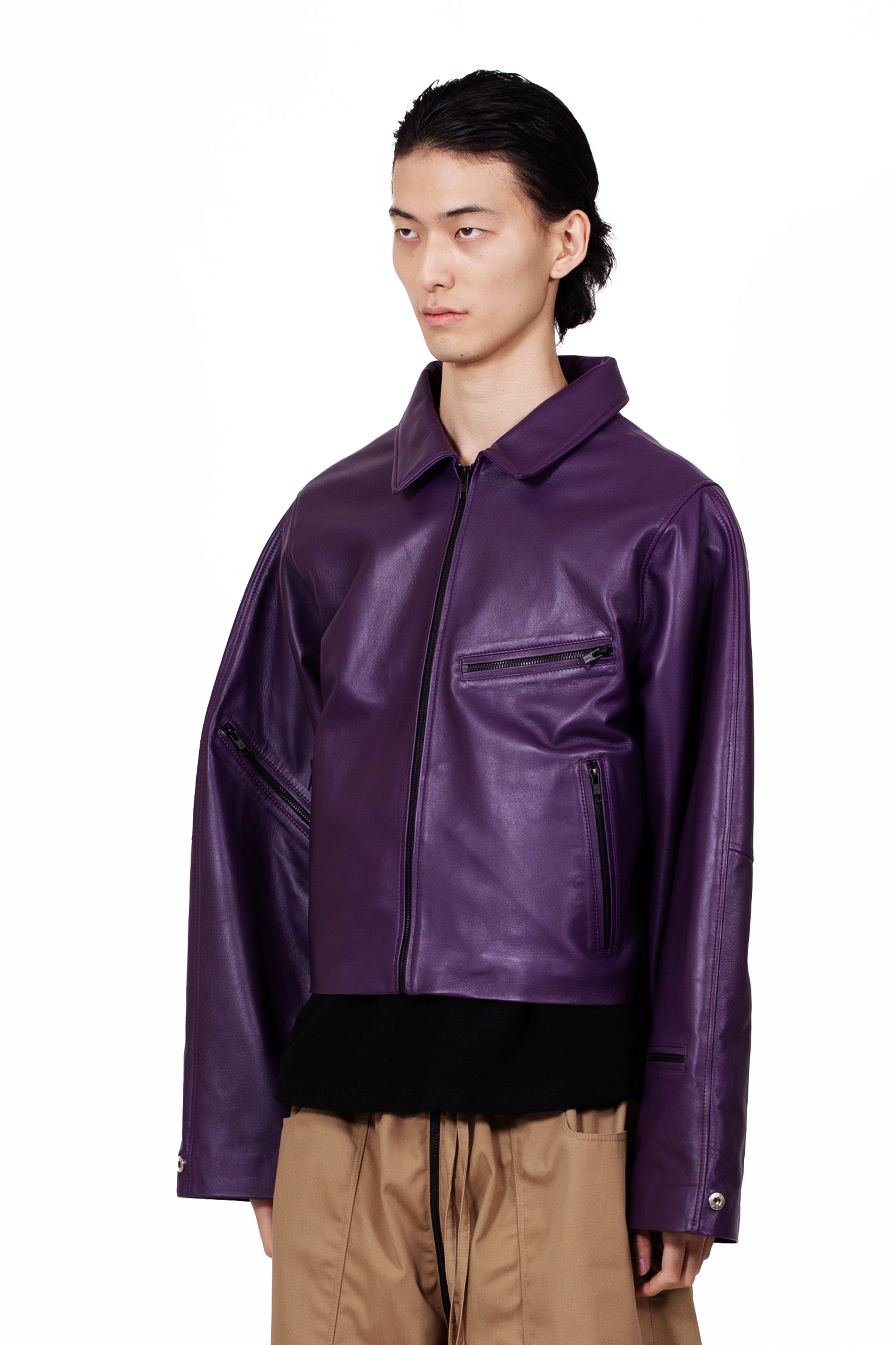 MANCANDY Racer Leather Jacket featuring a cropped oversized silhouette, open collar, black metal hardware, sleeve zip pocket and utility-inspired detailing.