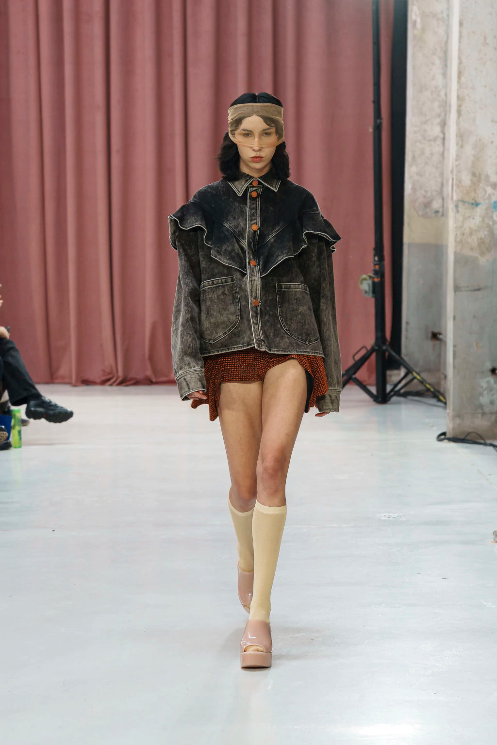 Oversized acid wash denim overshirt by MANCANDY featuring a sculptural western ruffle yoke, patch pockets, contrast stitching and metal jean buttons.